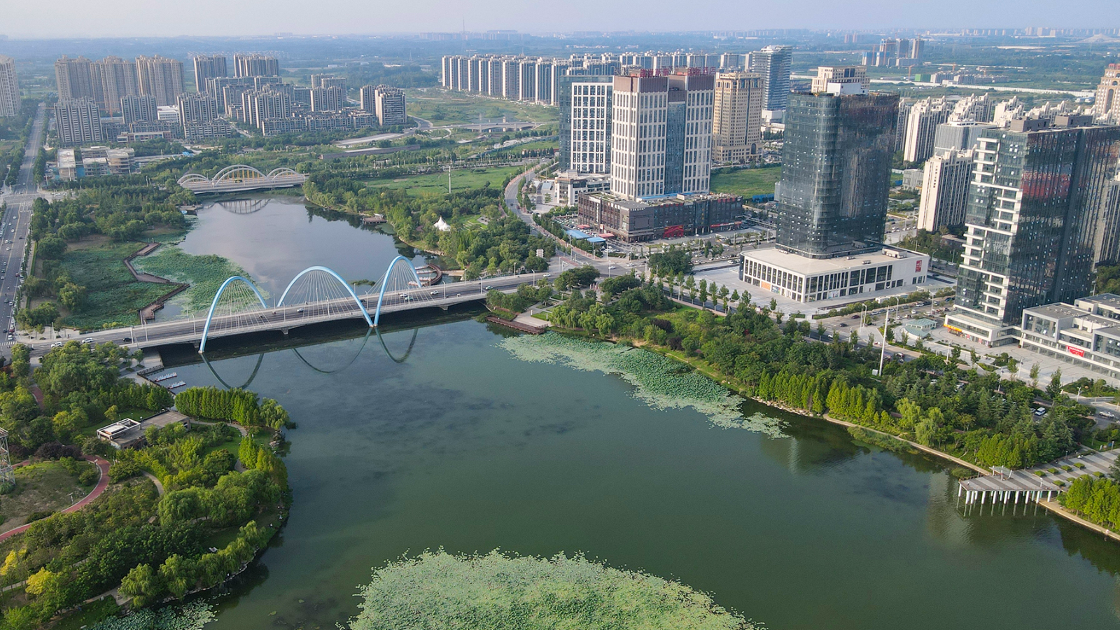 A solarpunk city with white skyscrapers, plants and the ocean nearby